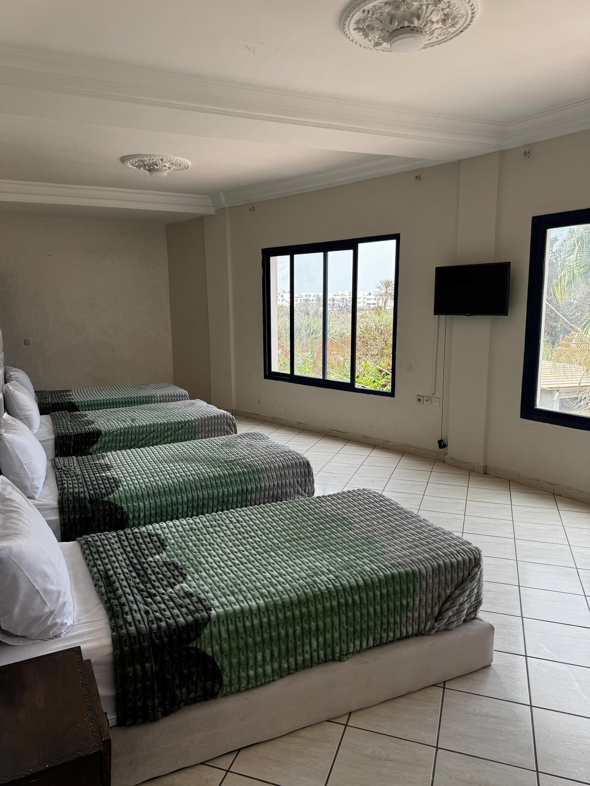 Nomad Spirit Hotel multi-bed guest room with garden-facing windows