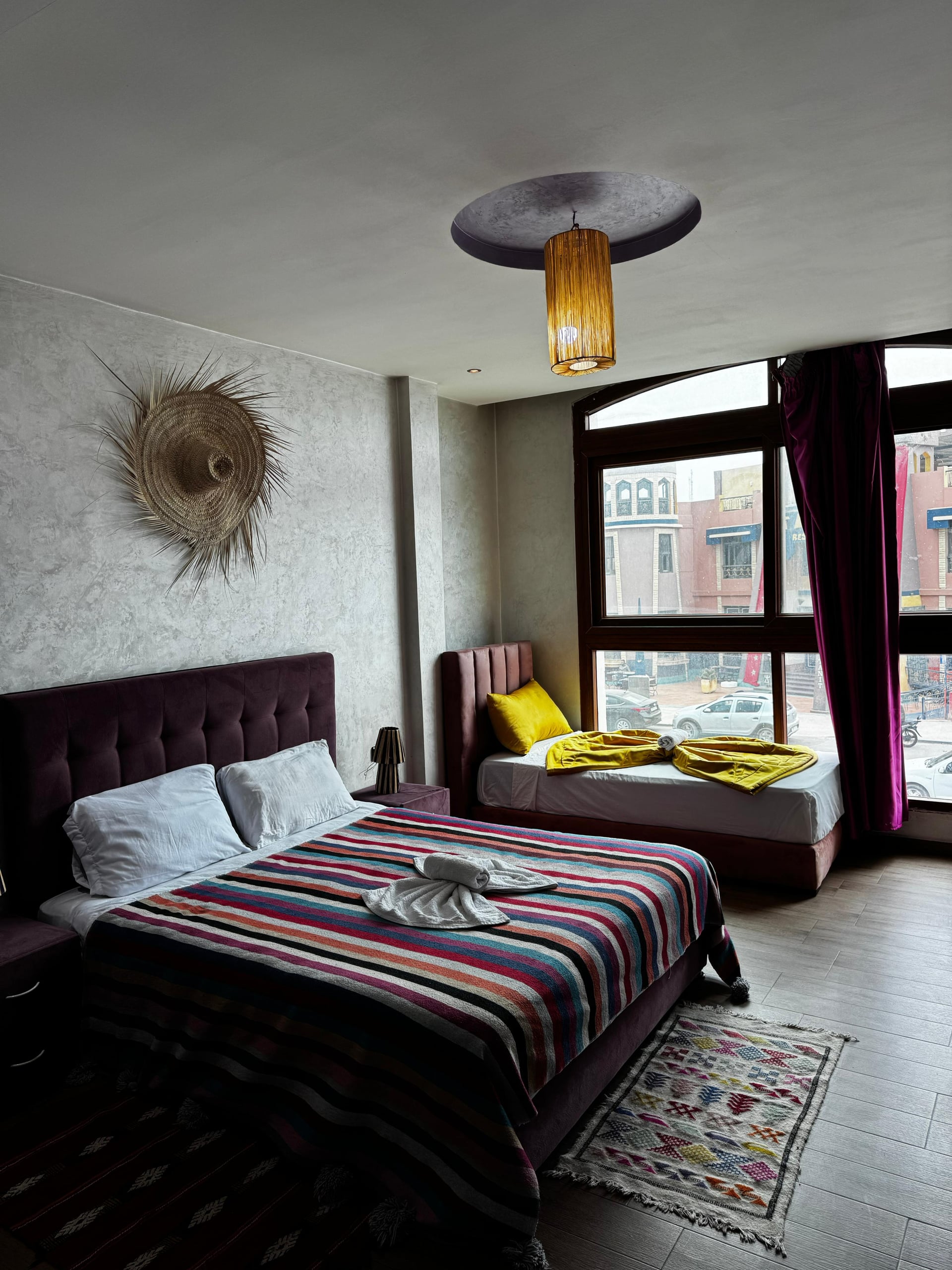 Nomad Spirit Hotel guest room featuring arched bay windows