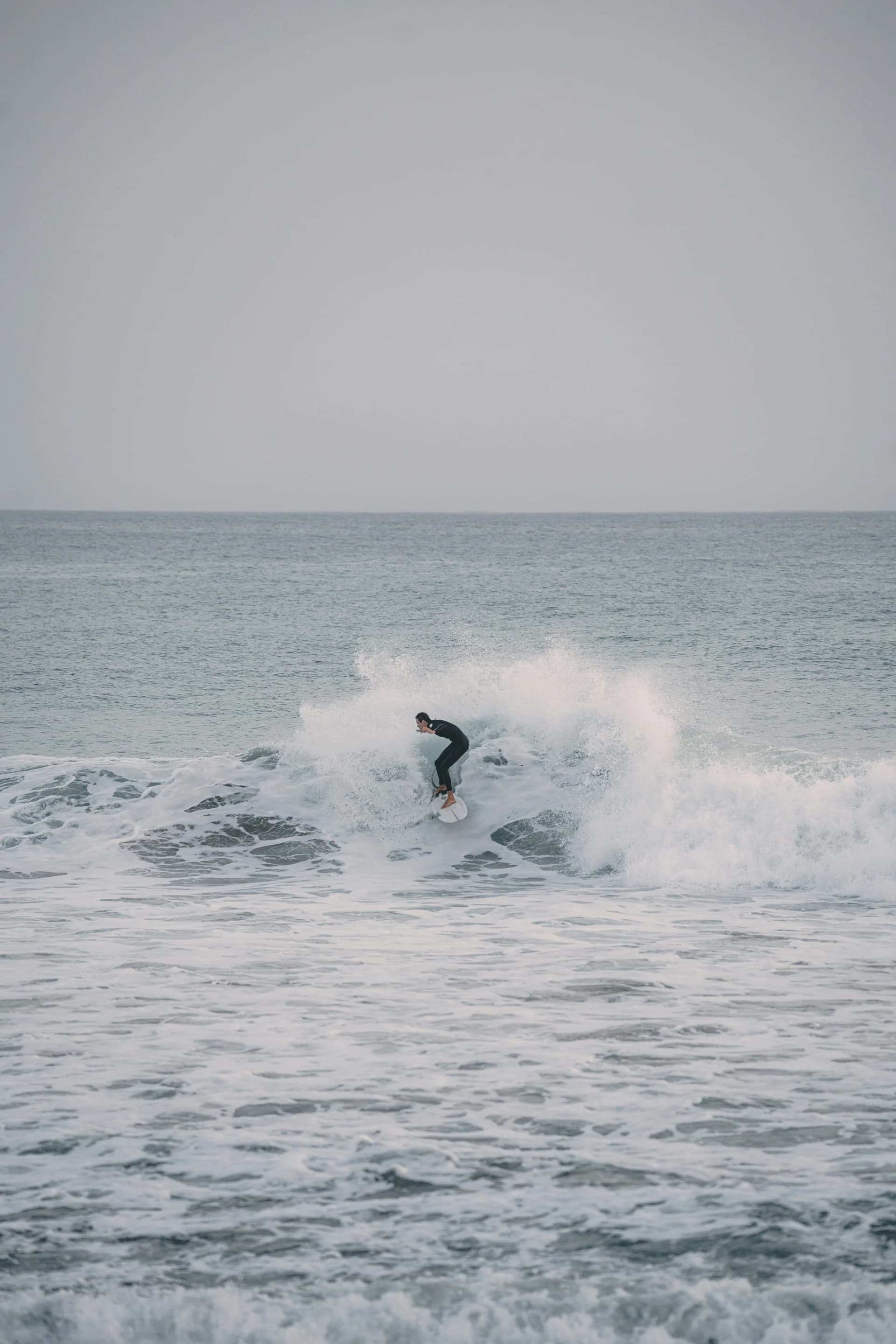 Surfer catching an Atlantic wave near Taghazout, Morocco